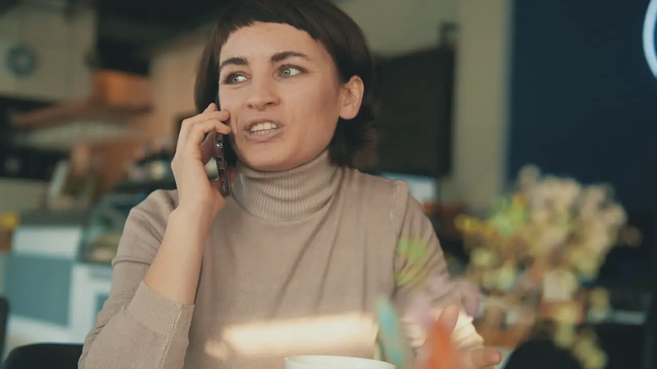 Portrait Of Female Having A Call In A Coffee Shop