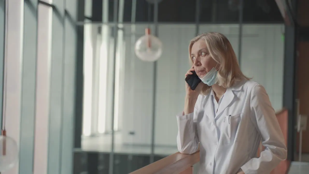 A Blonde Middle Aged Female Doctor Talks On The Cell Phone 1