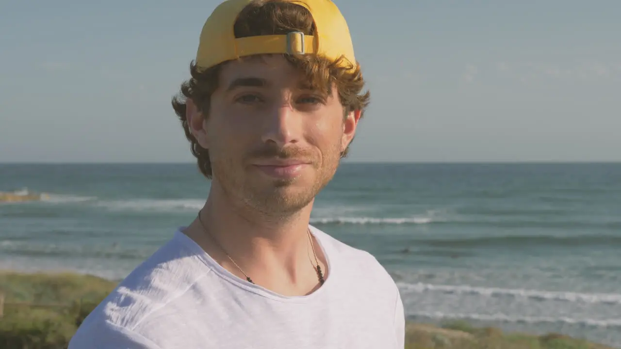 Portrait Of Athlete Man With Cap Smiling And Looking At Camera