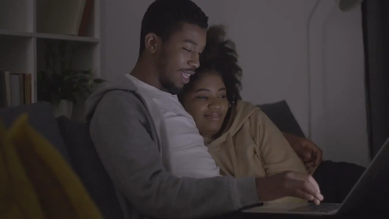 Young Couple Choosing A Movie To Watch On The Laptop