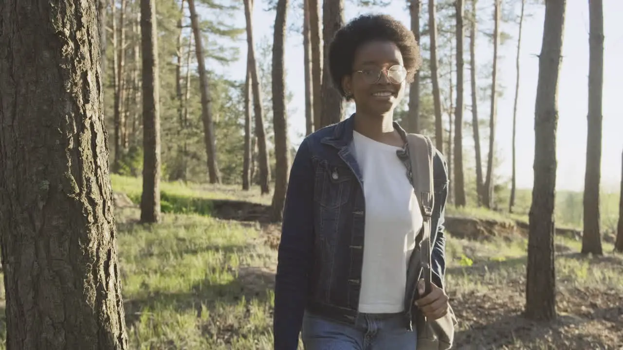 A Pretty Young Woman Takes A Walk In The Forest At Sunset