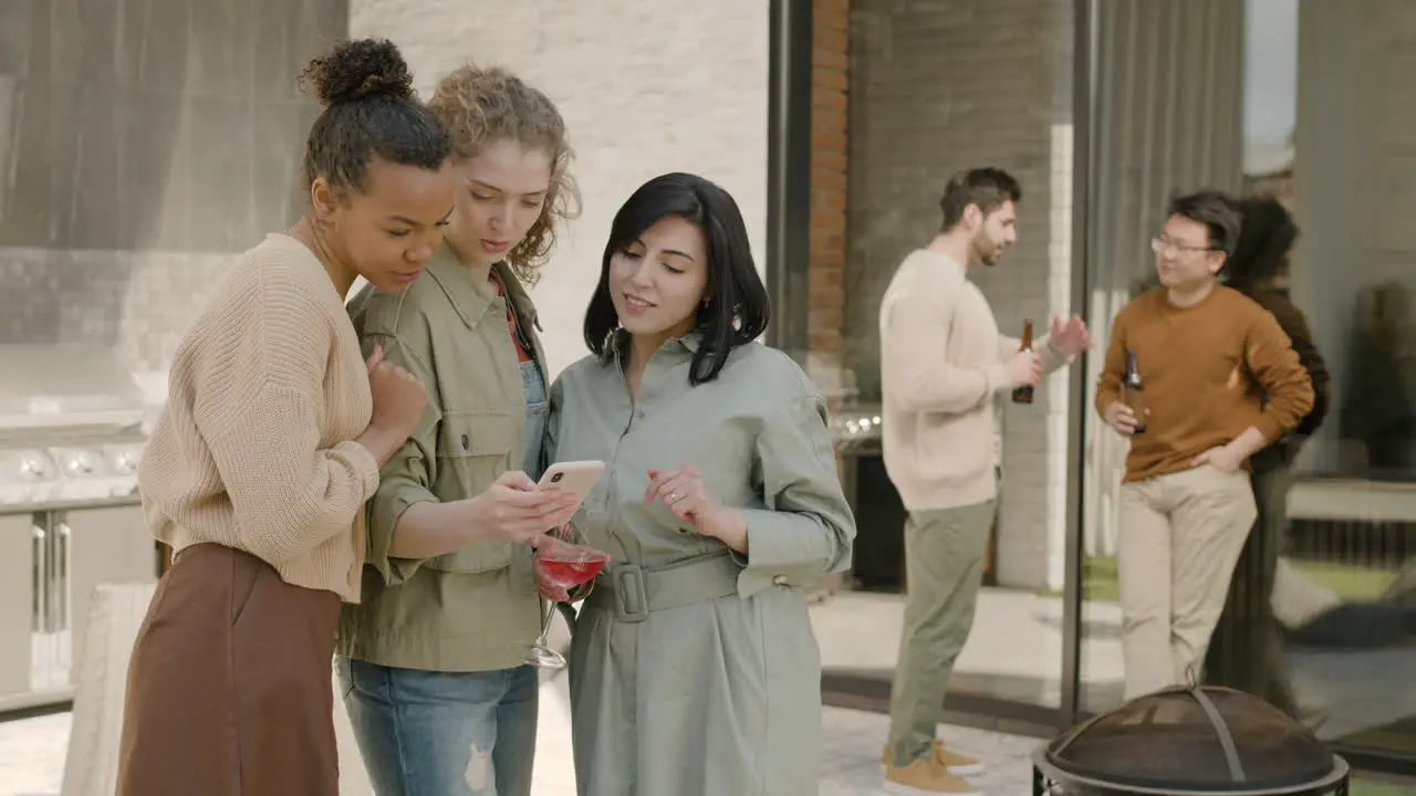 A Beautiful Group Of Three Girls Looking Something At The Phone 1