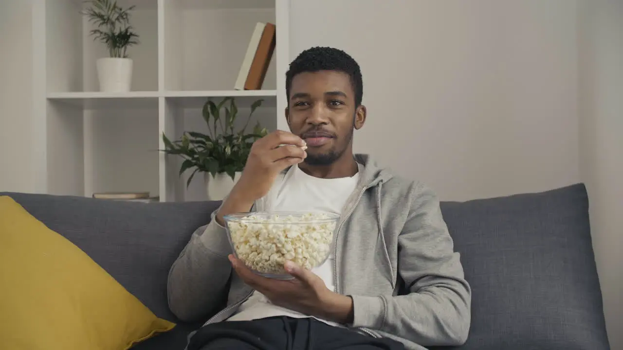 Young Man Enjoying A Movie And Eating Popcorn