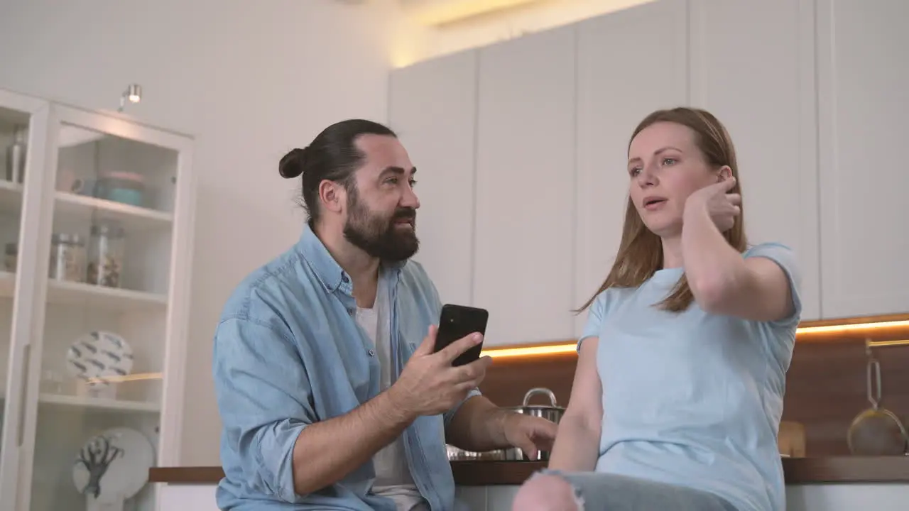 Attractive Woman Gets Angry Looking At Her Bearded Partner's Cell Phone 1