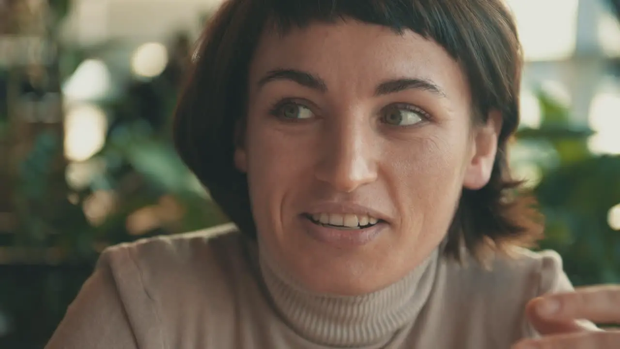 Portrait Of Young Woman Talking To Her Friend In A Coffee Shop 1