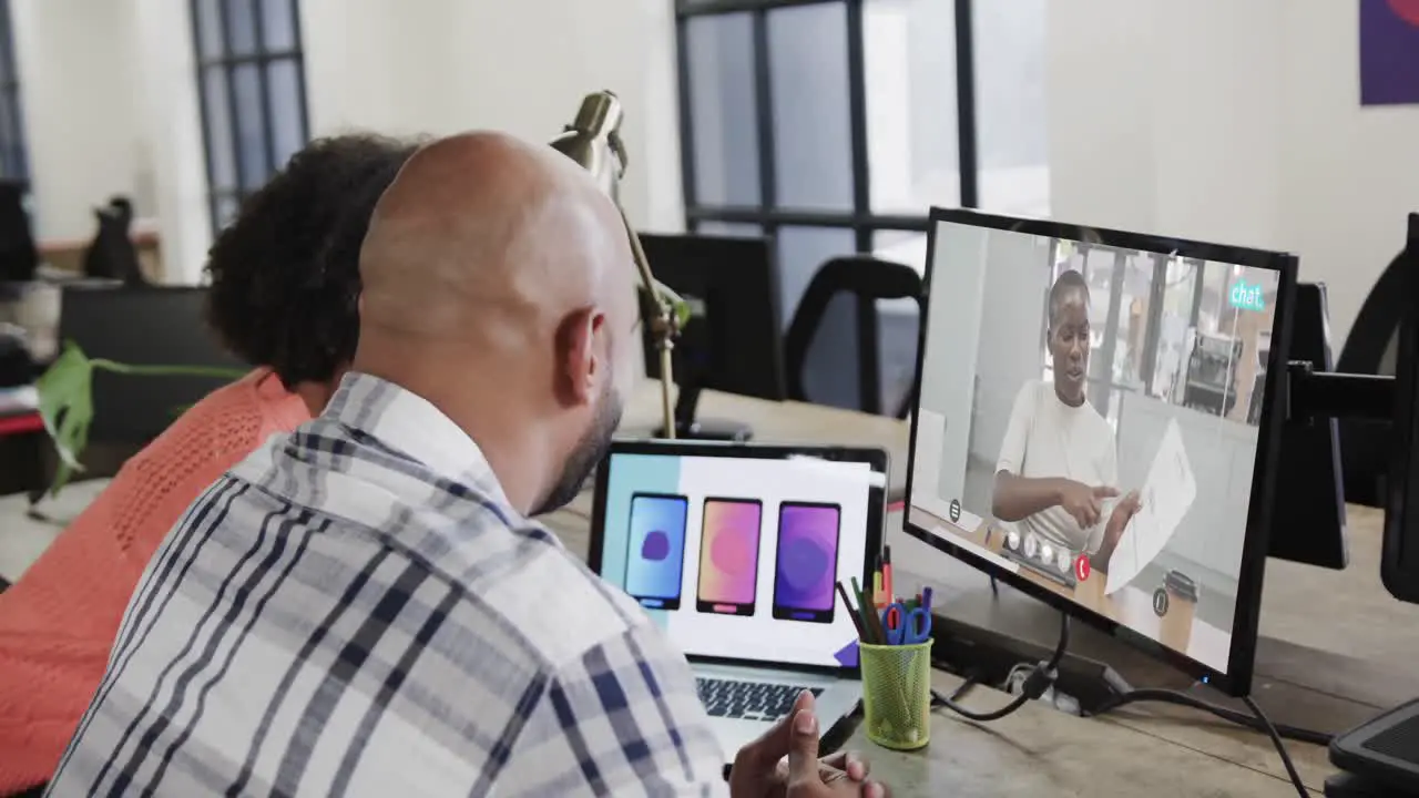 African american business people on video call with african american female colleague on screen