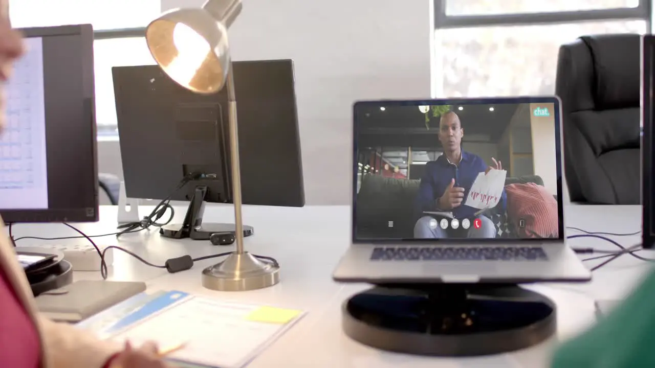 Laptop video call with african american male colleague on screen