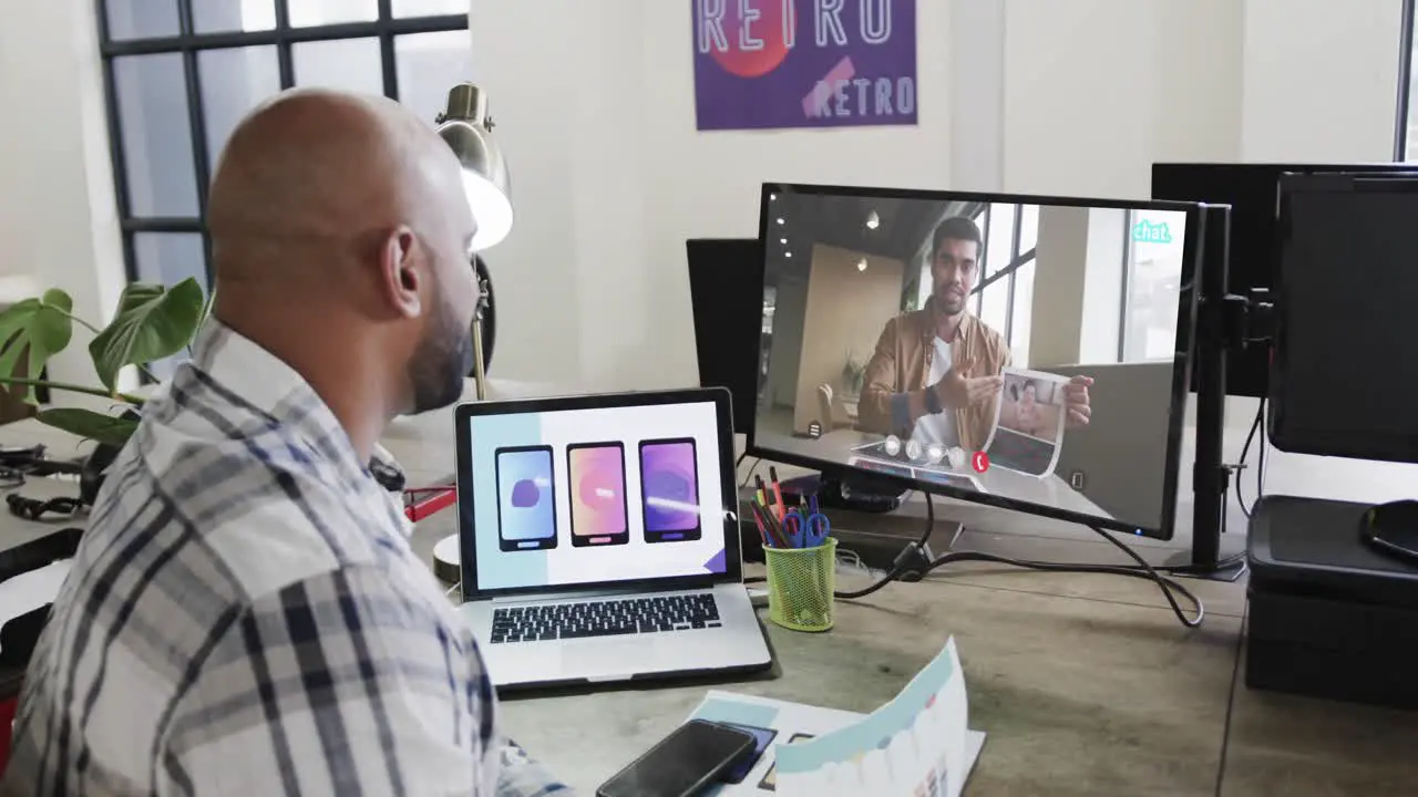 African american businessman on video call with african american male colleague on screen