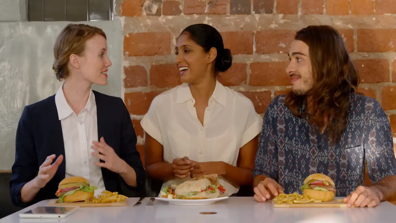 Colleagues interacting with each other while having their meal 4k