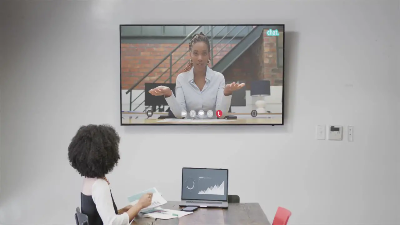 African american businesswoman on video call with african american female colleague on screen