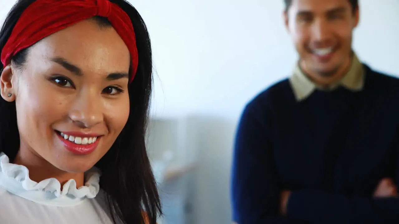 Smiling female and male executives standing in office 4k