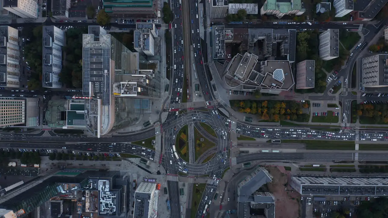 Aerial birds eye overhead top down panning view of traffic jam around large roundabout in city centre Warsaw Poland