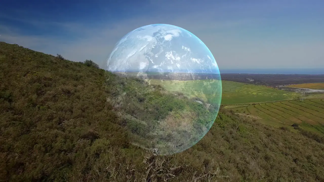 Animation of spinning globe over landscape in mountains