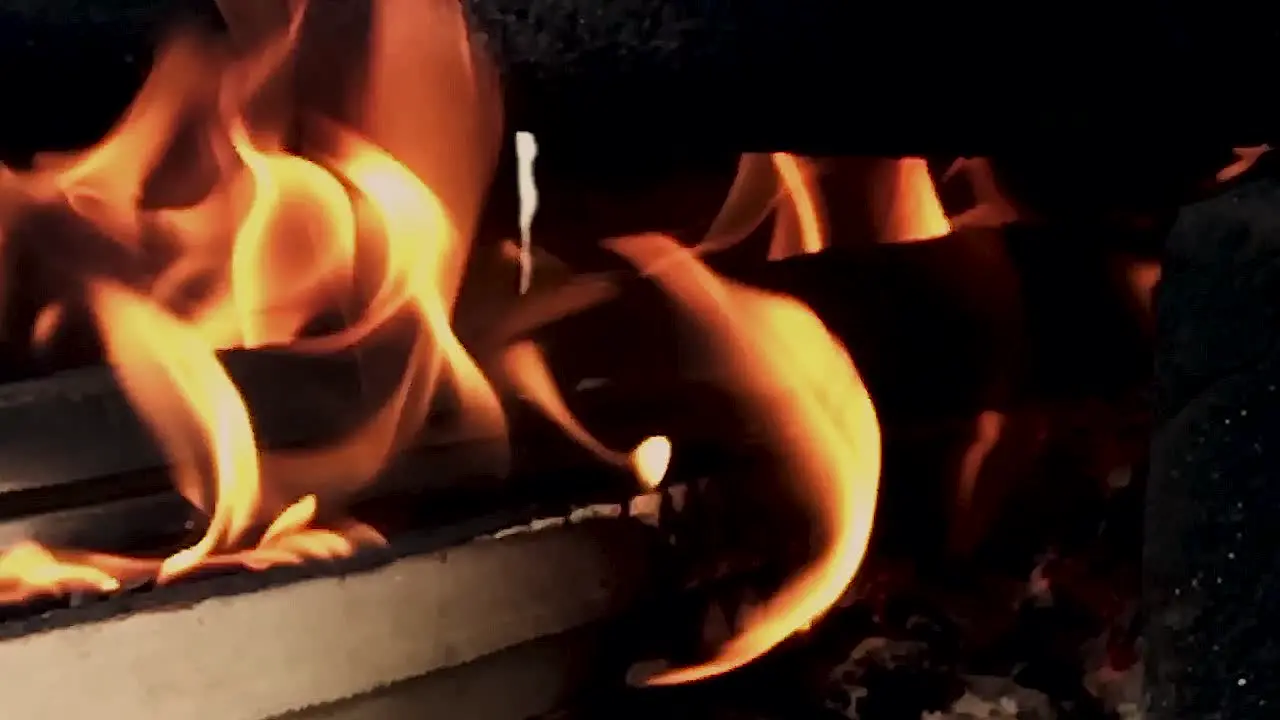 Slow Motion Closeup on the fire of Indian traditional style hand made fire place to cook the food with wood coal etc