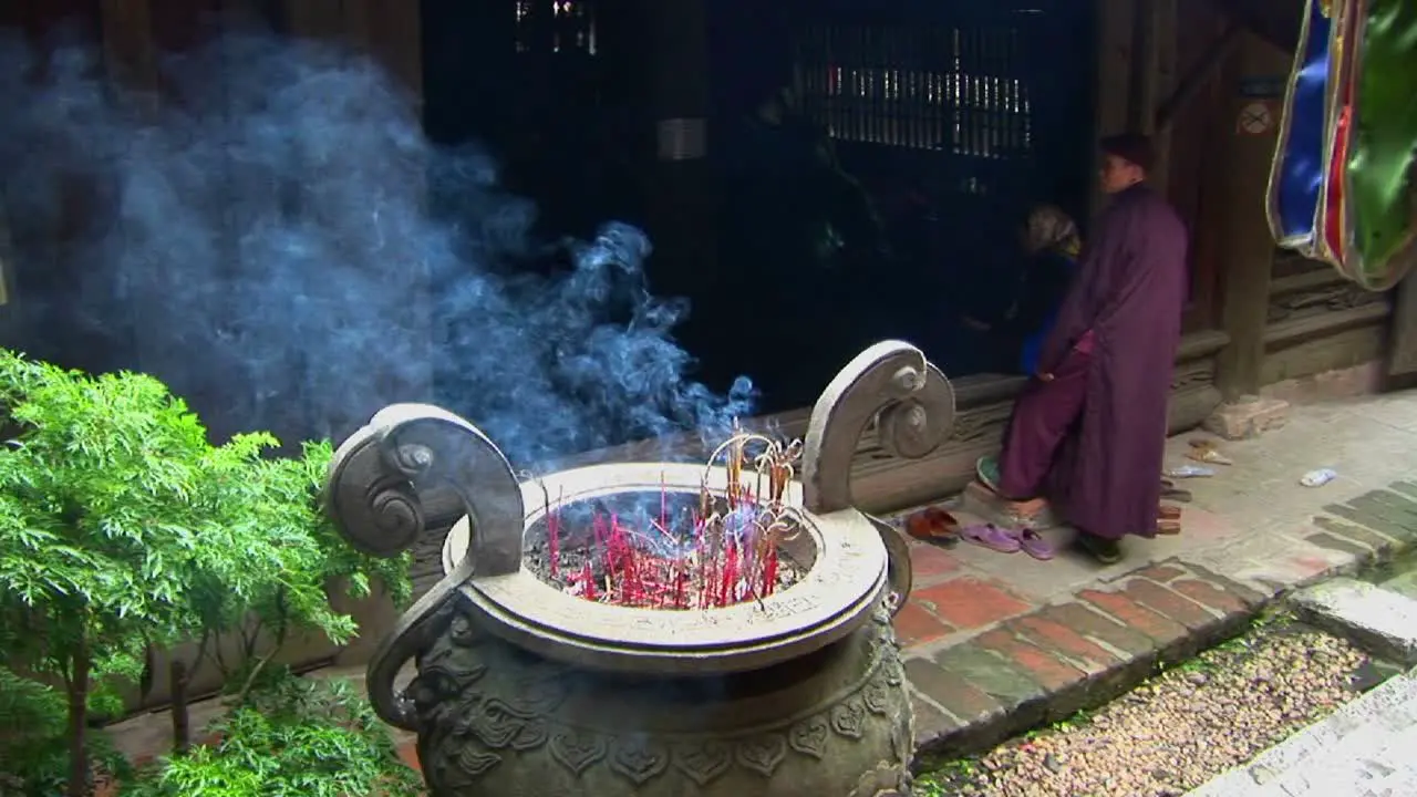 Monks gather as incense scents the air at a Vietnamese temple