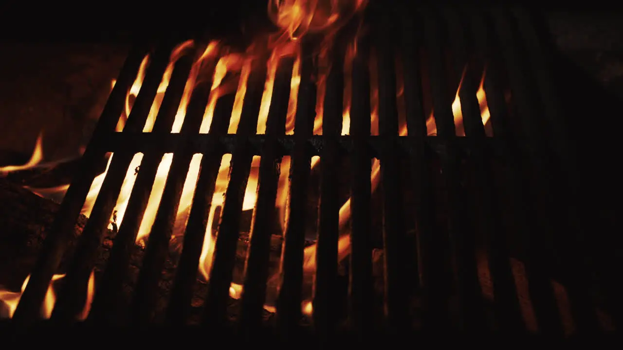 The fire burns under the hot grill grill