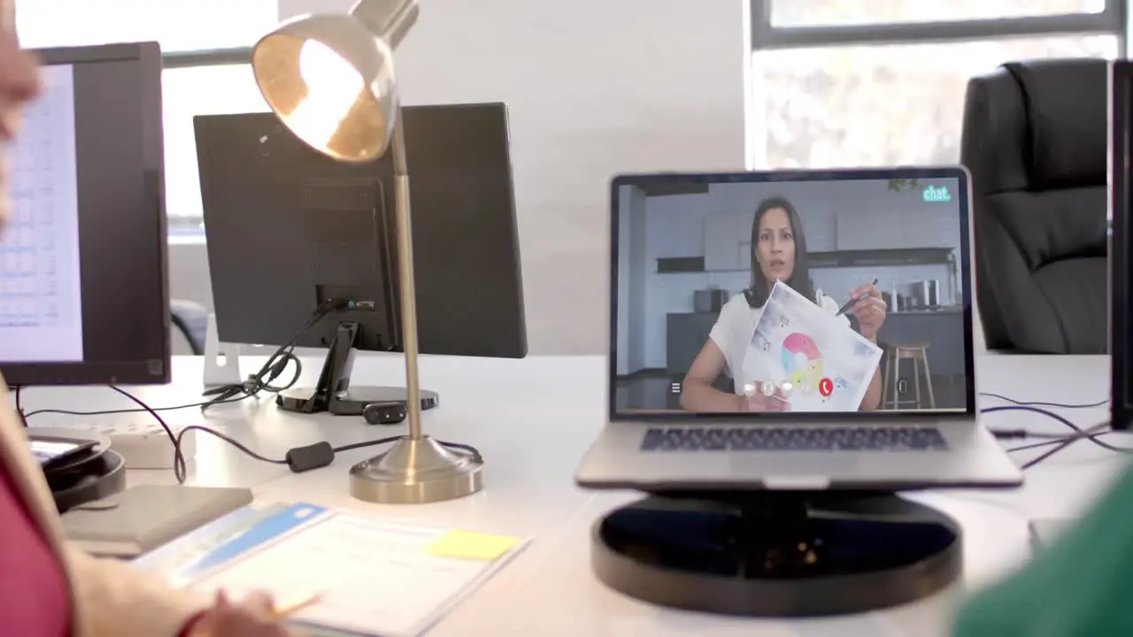 Laptop video call with caucasian female colleague on screen