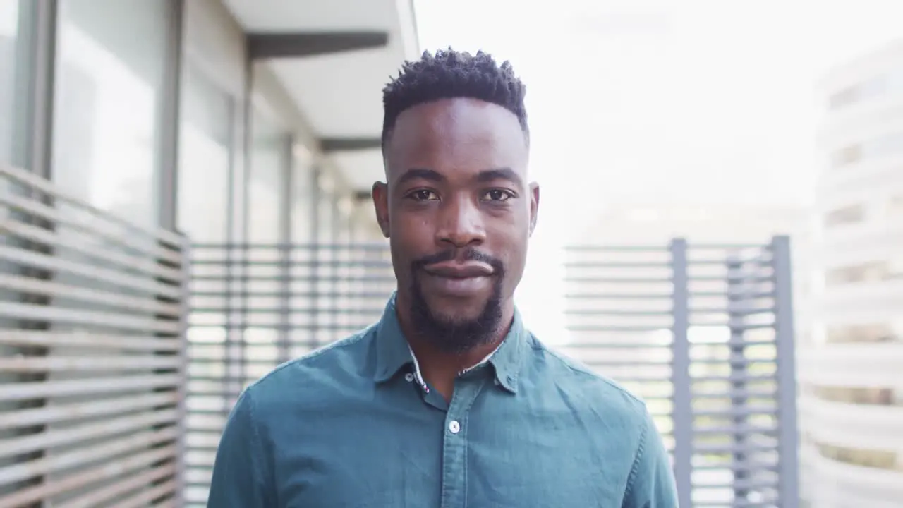 Portrait of happy african american businessman in creative office