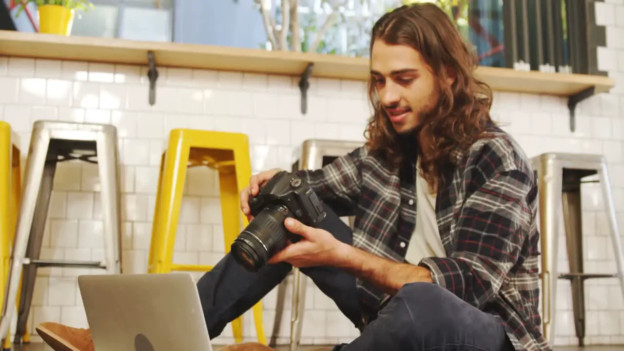 Creative executive reviewing the photos in his digital camera 4K 4k