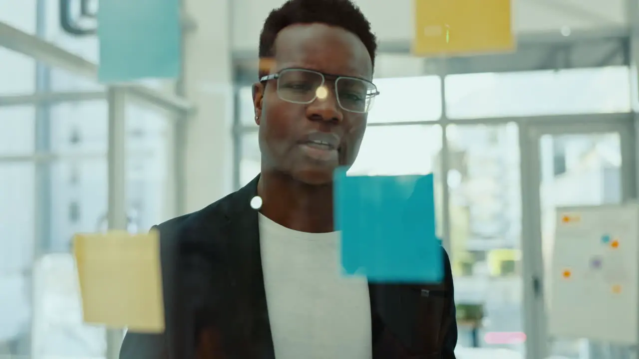 Thinking glass and business black man with sticky