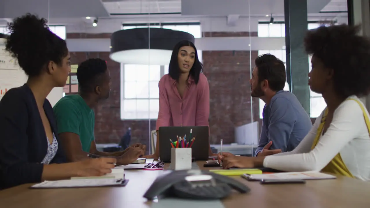 Mixed race businesswoman having a meeting with colleagues in meeting room