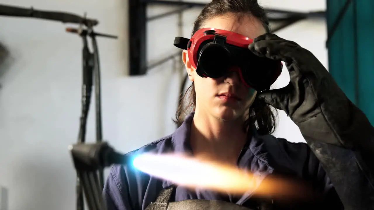 Female welder welding a metal