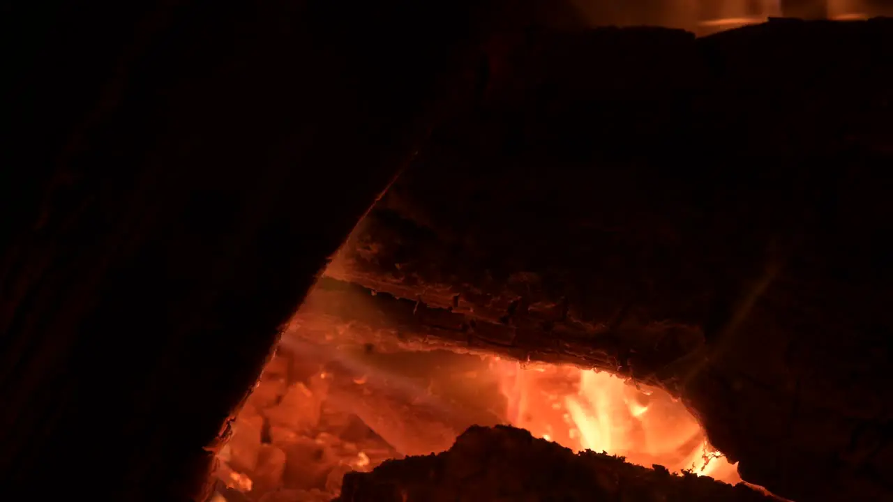 close up of yellow fire flame burning a piece of wood