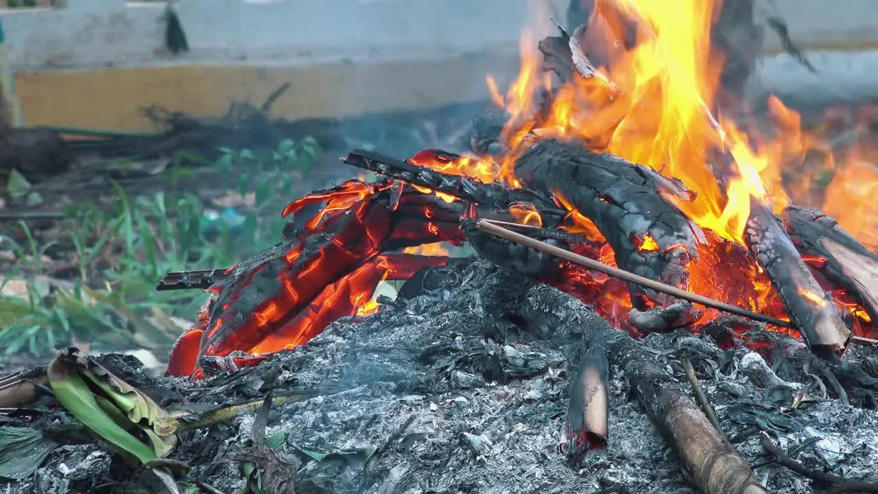 Medium Shot of a Small Fire Burning and Smouldering with Orange Flames