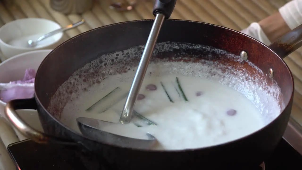 cooking homemade coconut balls in northern Thailand