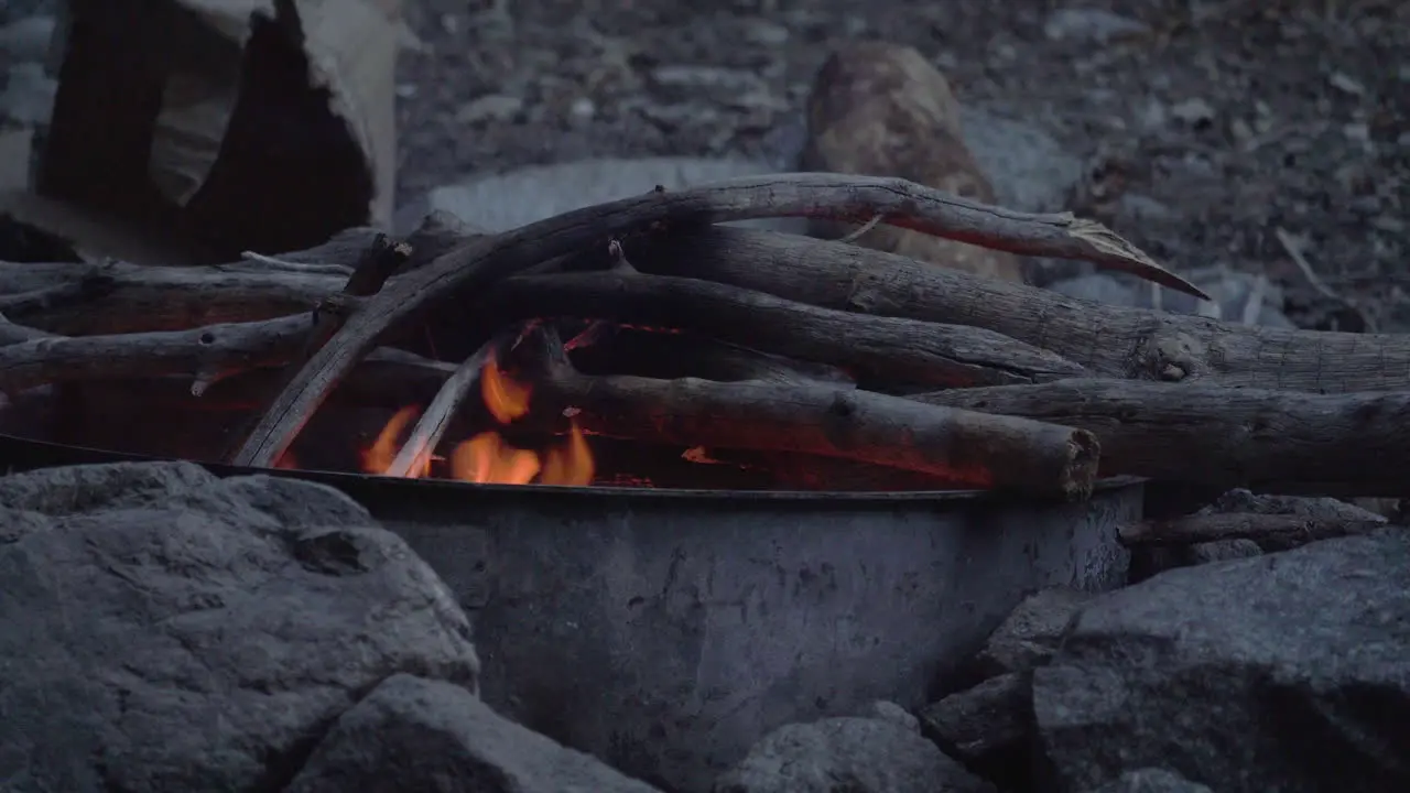 Close up of a campfire with camping stove for outdoor cooking after a day of hike trekking in the wilderness