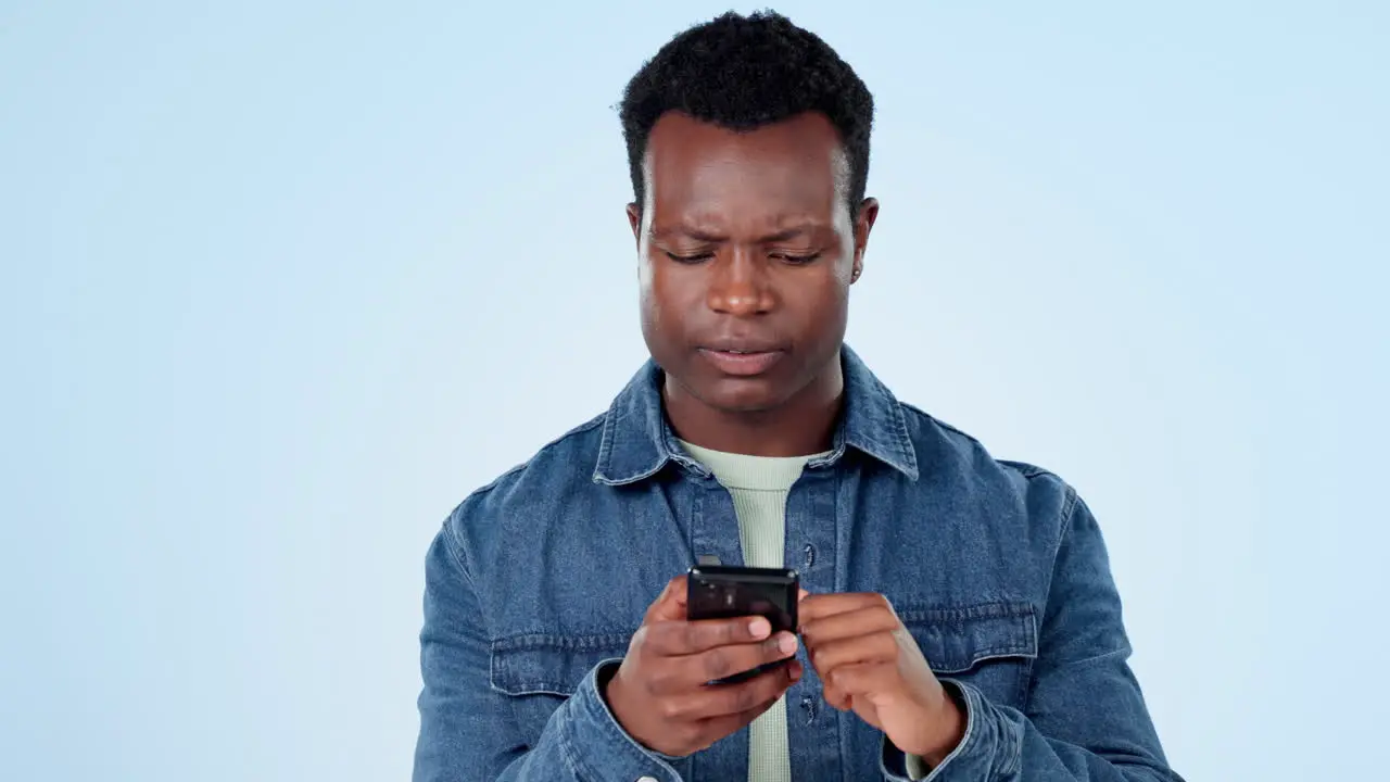 Black man in studio with phone