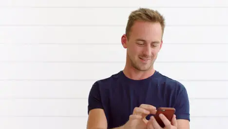 Happy young man using 5g phone against a white