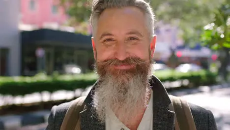 Smiling senior man laughing on a city street