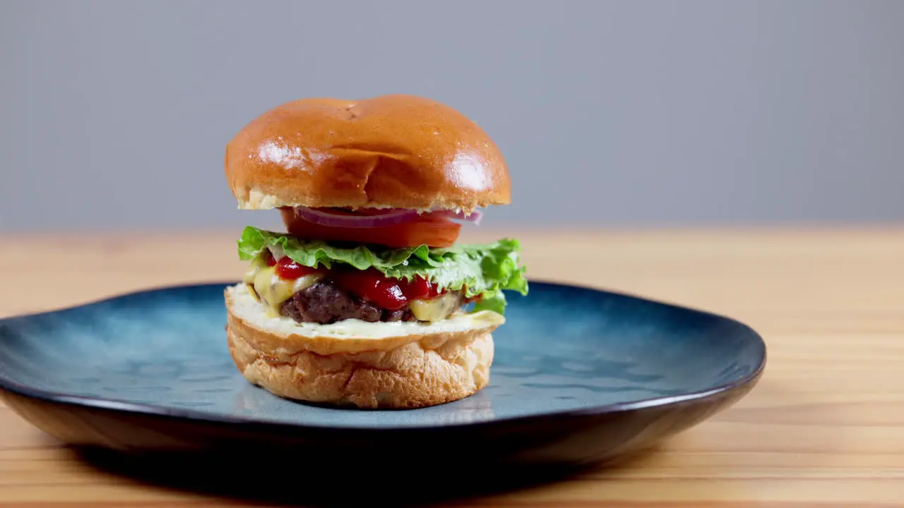 Person hand and fast food burger on mockup space