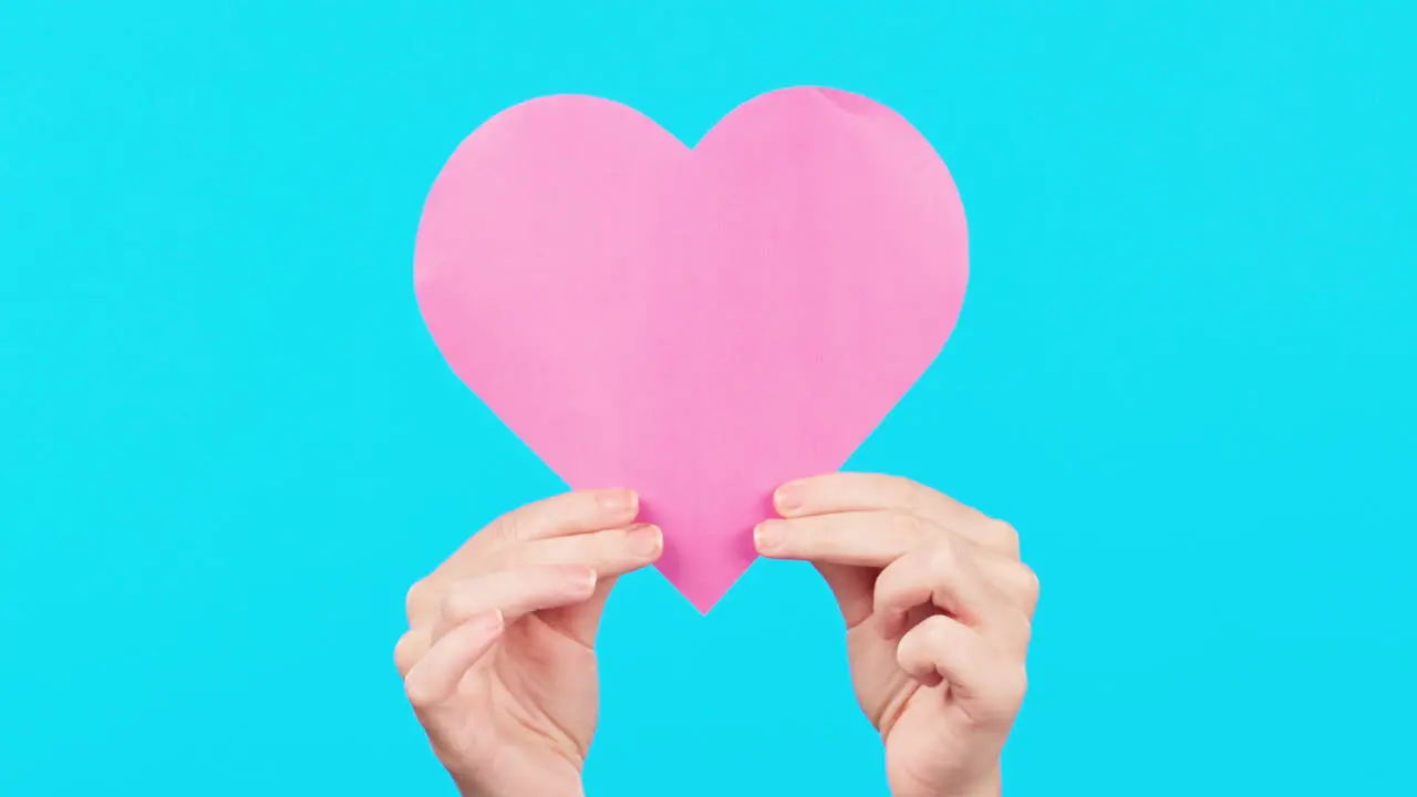 Blue background showing and hands with a heart