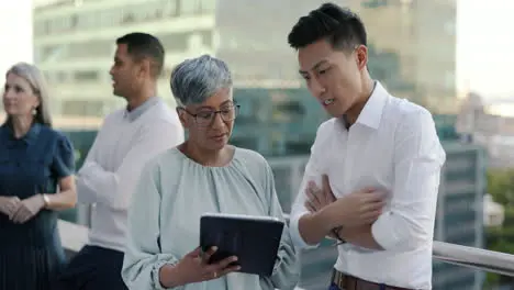 Rooftop business people and tablet planning