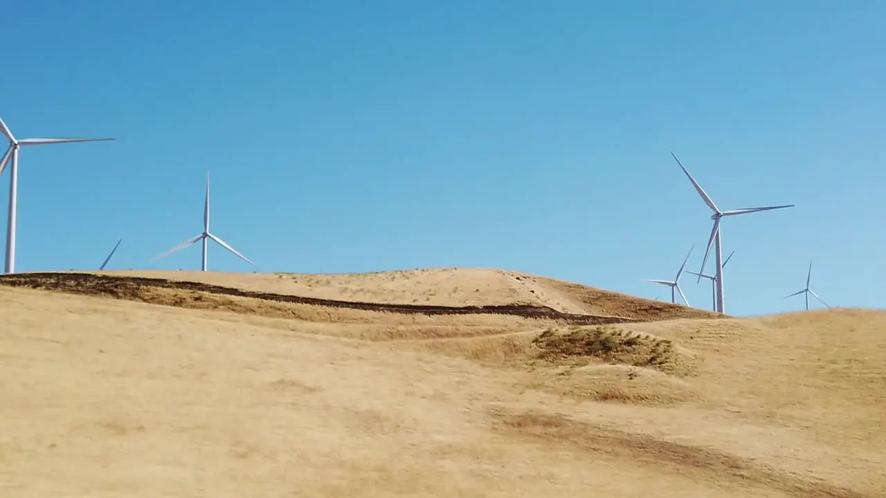 Windmills up close in slow-motion in California