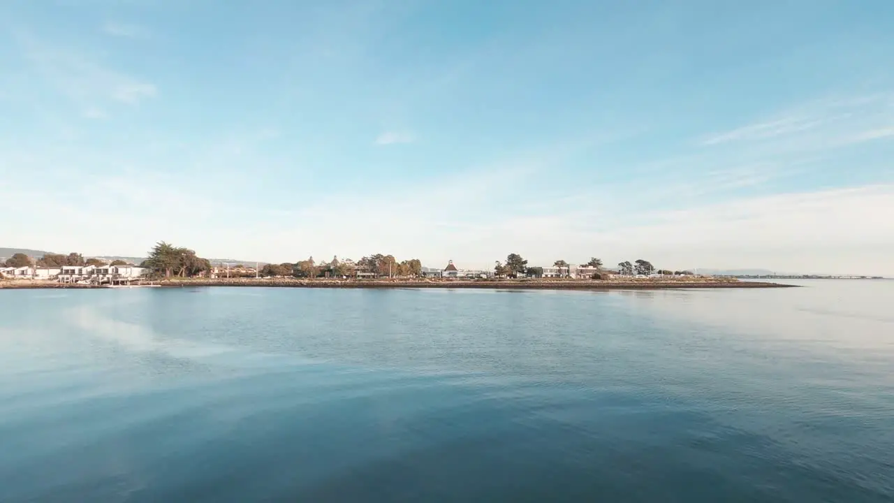 Calm silky waters under the blue skies over the bay near the beach