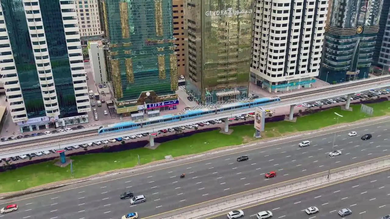 Main highway in Dubai with skyscrapers in the background during a sunny day