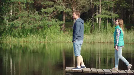 Young people rest on wooden bridge by river Youth enjoying weekend