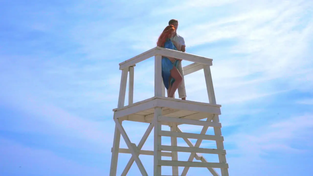 Love couple hugging on sky background Romantic couple on watchtower