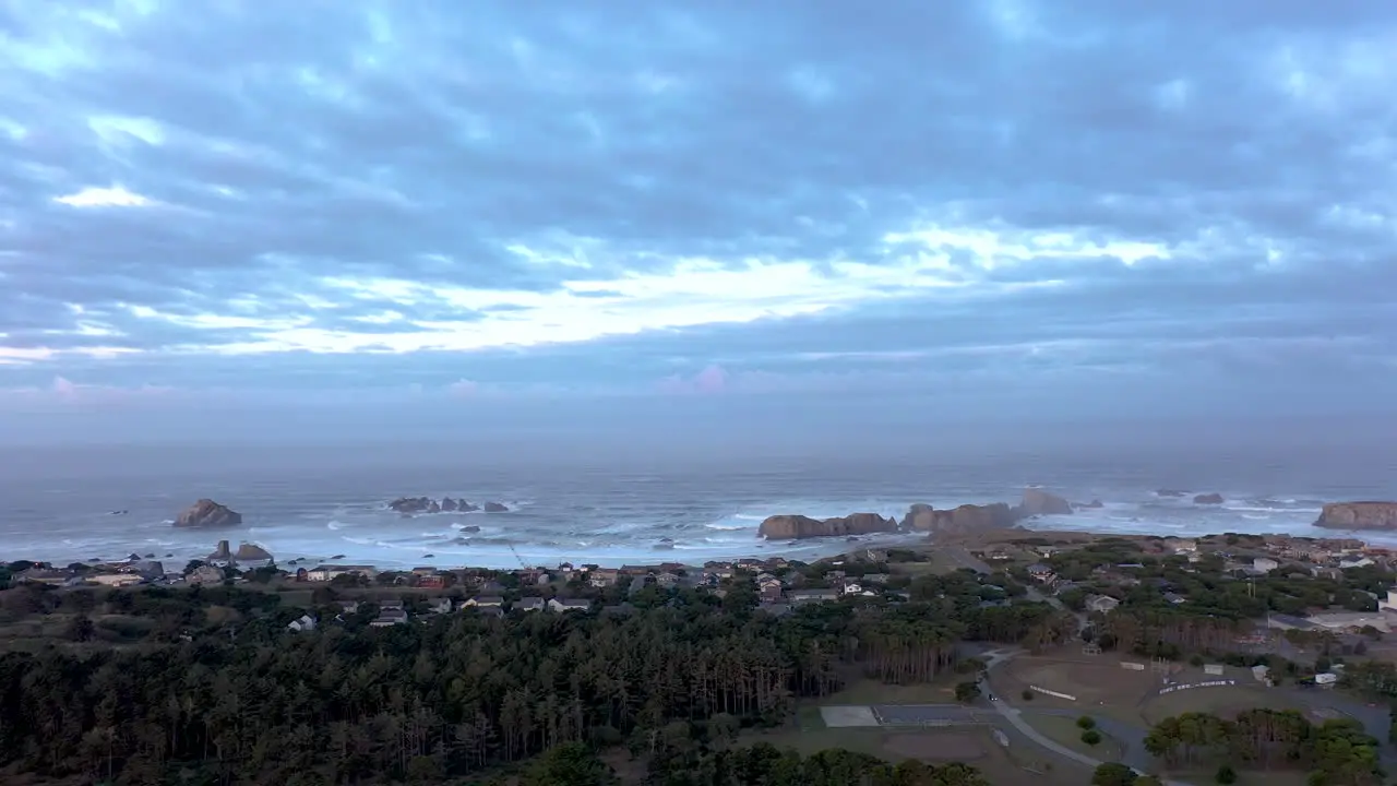 Aerial view of Bandon Beach with sea stacks at dawn panning shot