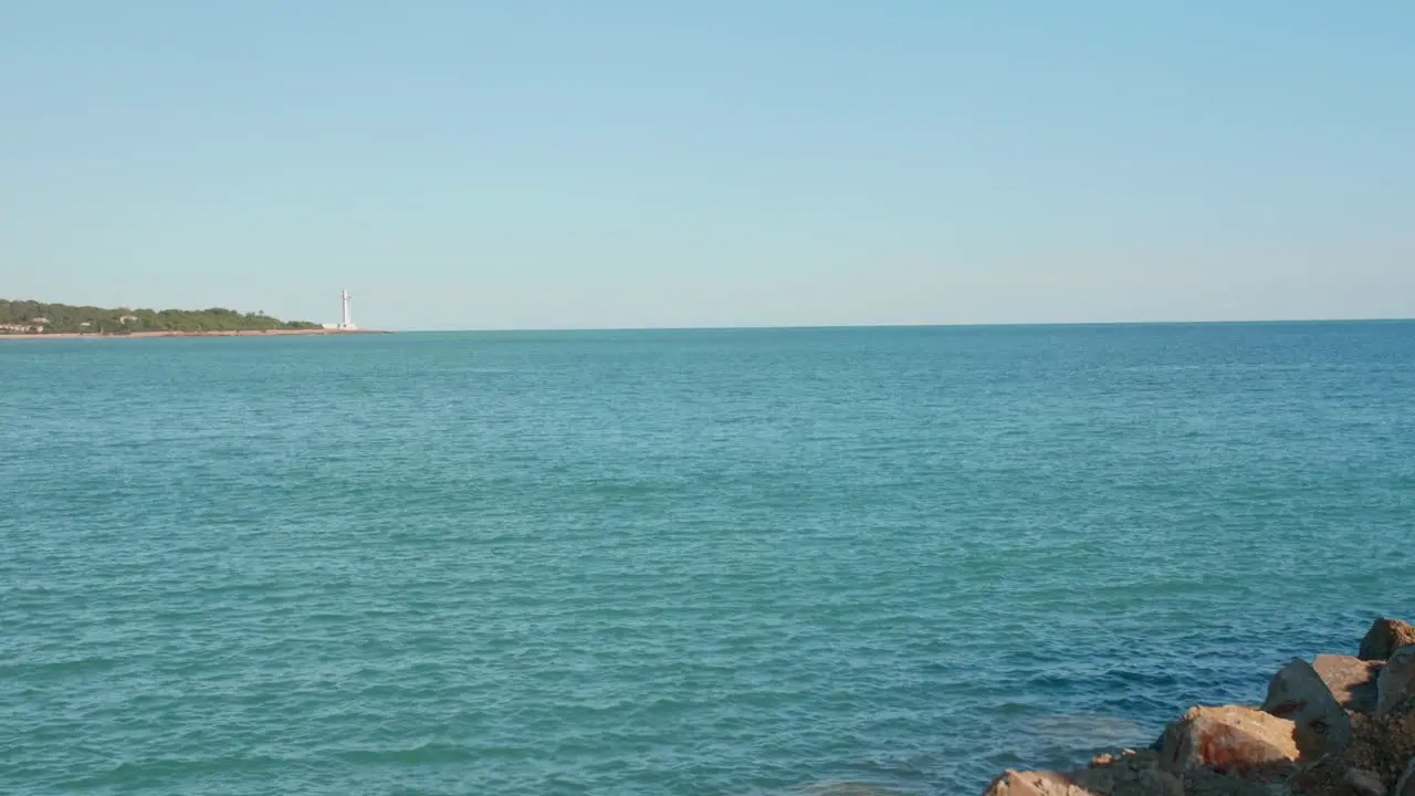 Seascape with a lighthouse in the distance