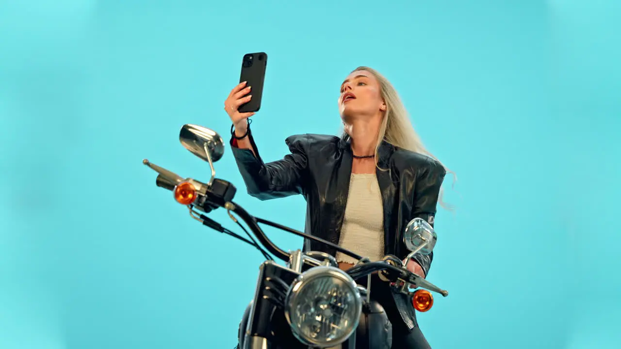 Selfie blue background or woman on motorcycle