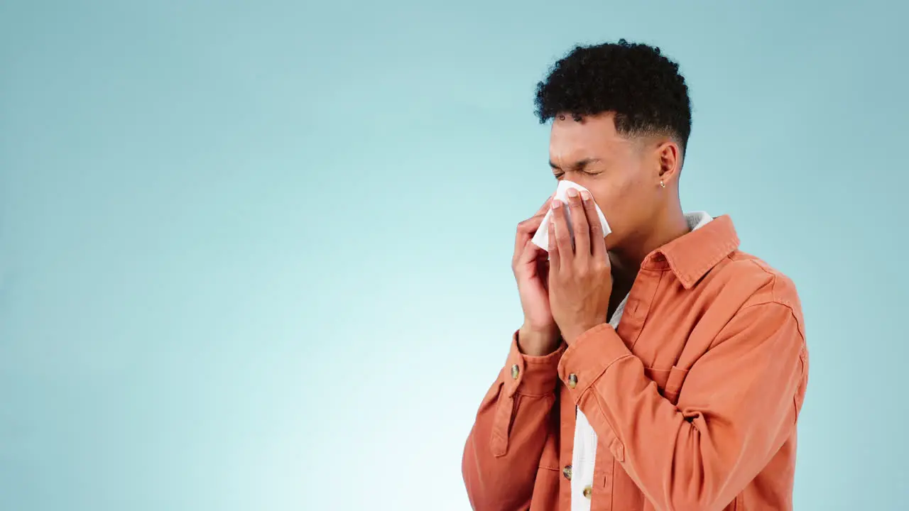 Tissue blue background and blowing nose