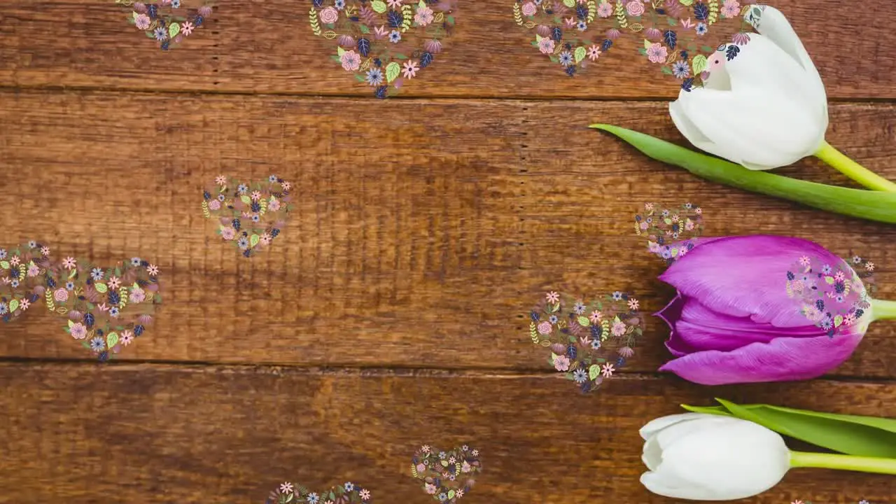 Animation of floating floral heart shapes over tulips on wood background