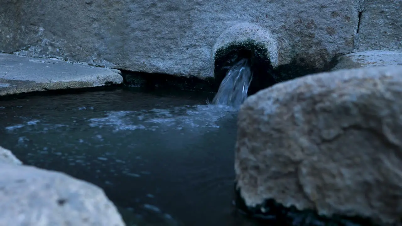 Boiling hot water bubbles out of natural spring piping in Spain