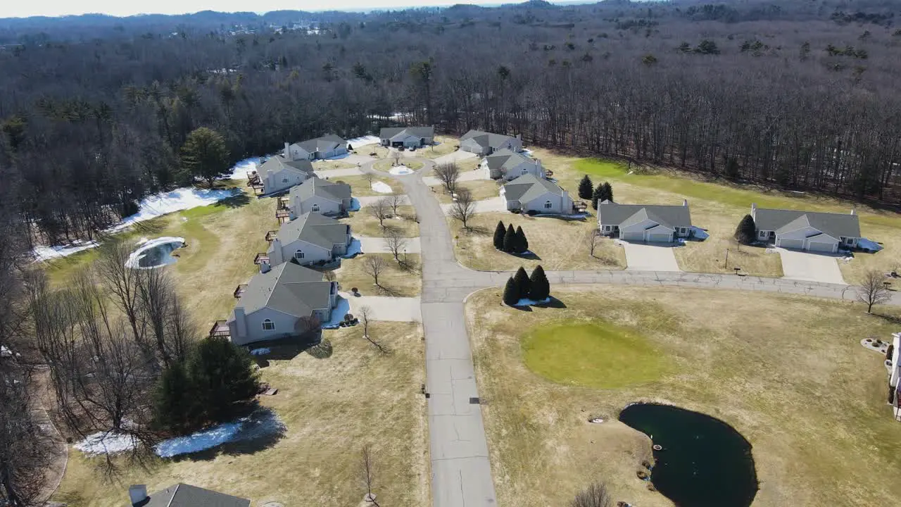 Smooth descent while moving forward to show a row of identical homes on a Cul-de-sac