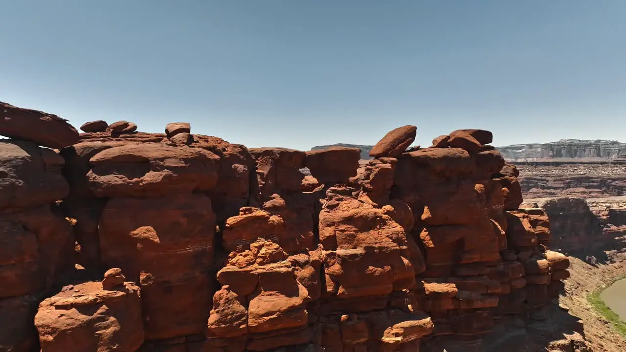 Aerial view of some rock formations on the Chicken Corners trail outside of Moab Utah with a glimpse of the Colorado River