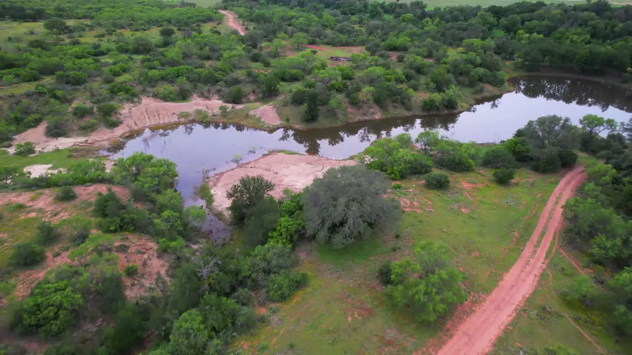 Aerial footage of a pond on a ranch in Texas